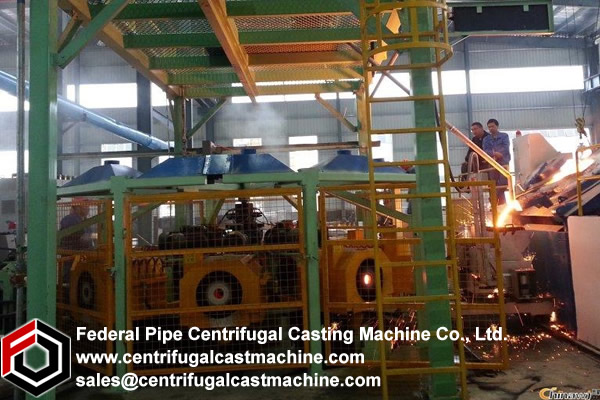 A centrifugal casting machine comprising a vertically movable